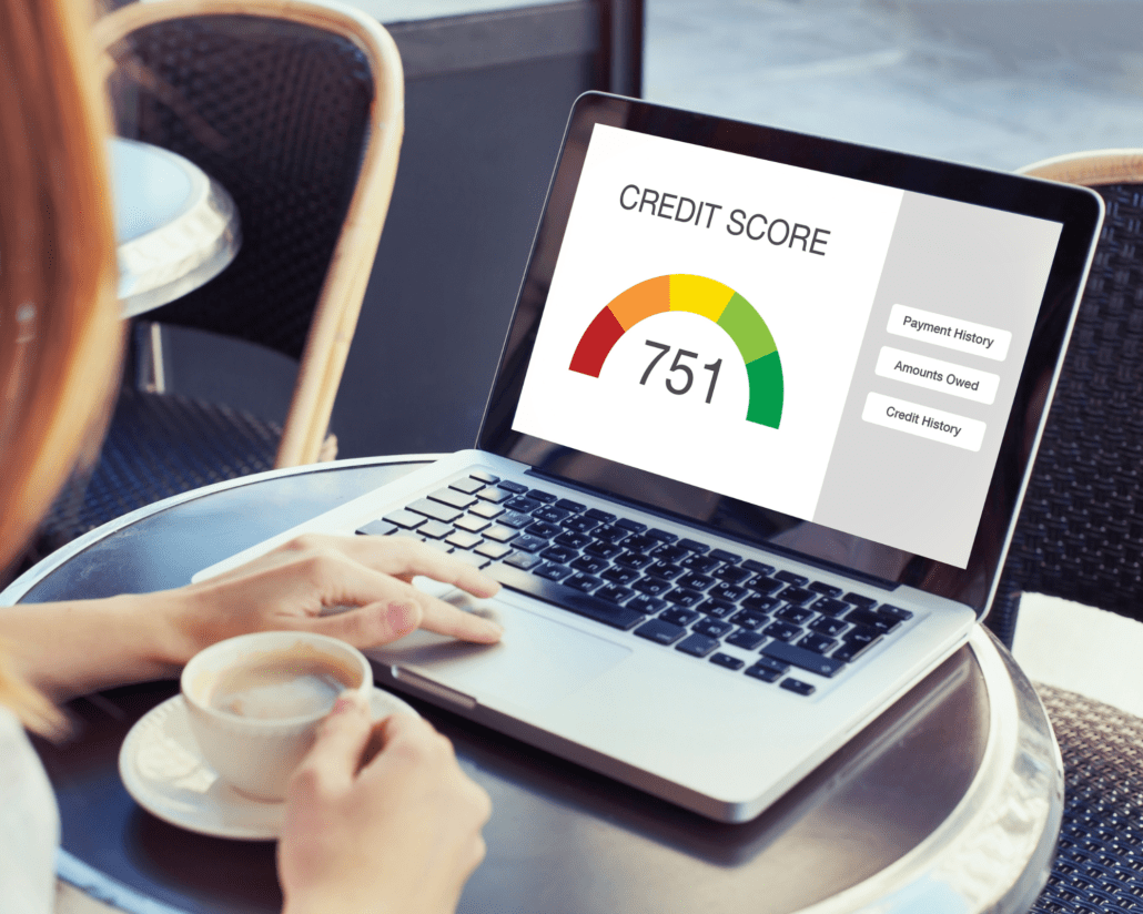 Laptop with Credit Score graph; someone looking at their credit score to determine how to improve credit after their bankruptcy. Improving credit after bankruptcy is easier than you think.