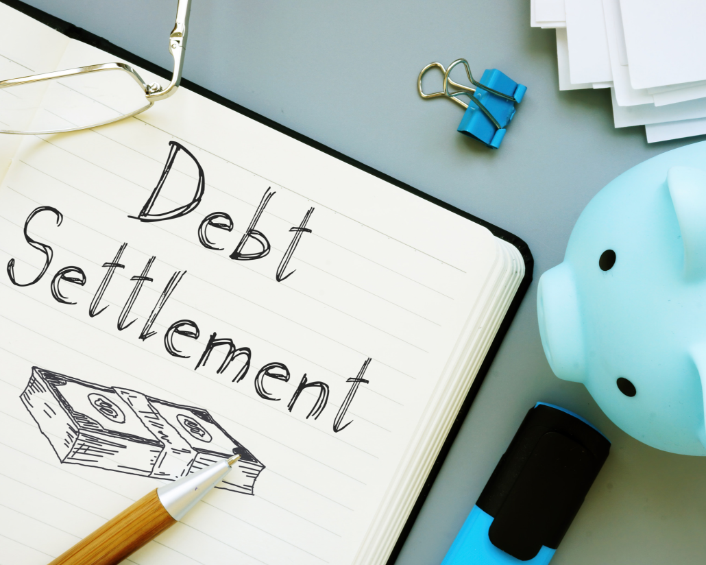 Debt Settlement written on a notebook. Calculating the tax consequences of debt settlement.